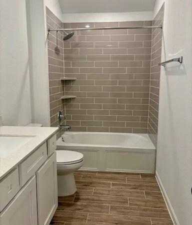 a bathroom with a shower sink vanity and mirror