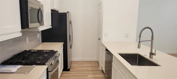 a view of a closet with white walls
