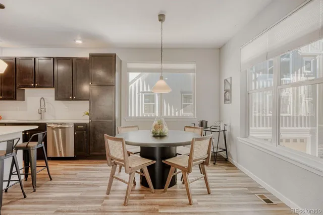 a dining room with furniture a chandelier and wooden floor