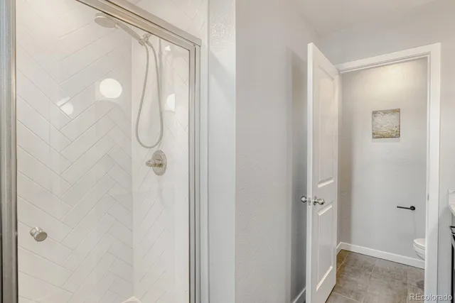 a bathroom with a granite countertop toilet a sink and a mirror