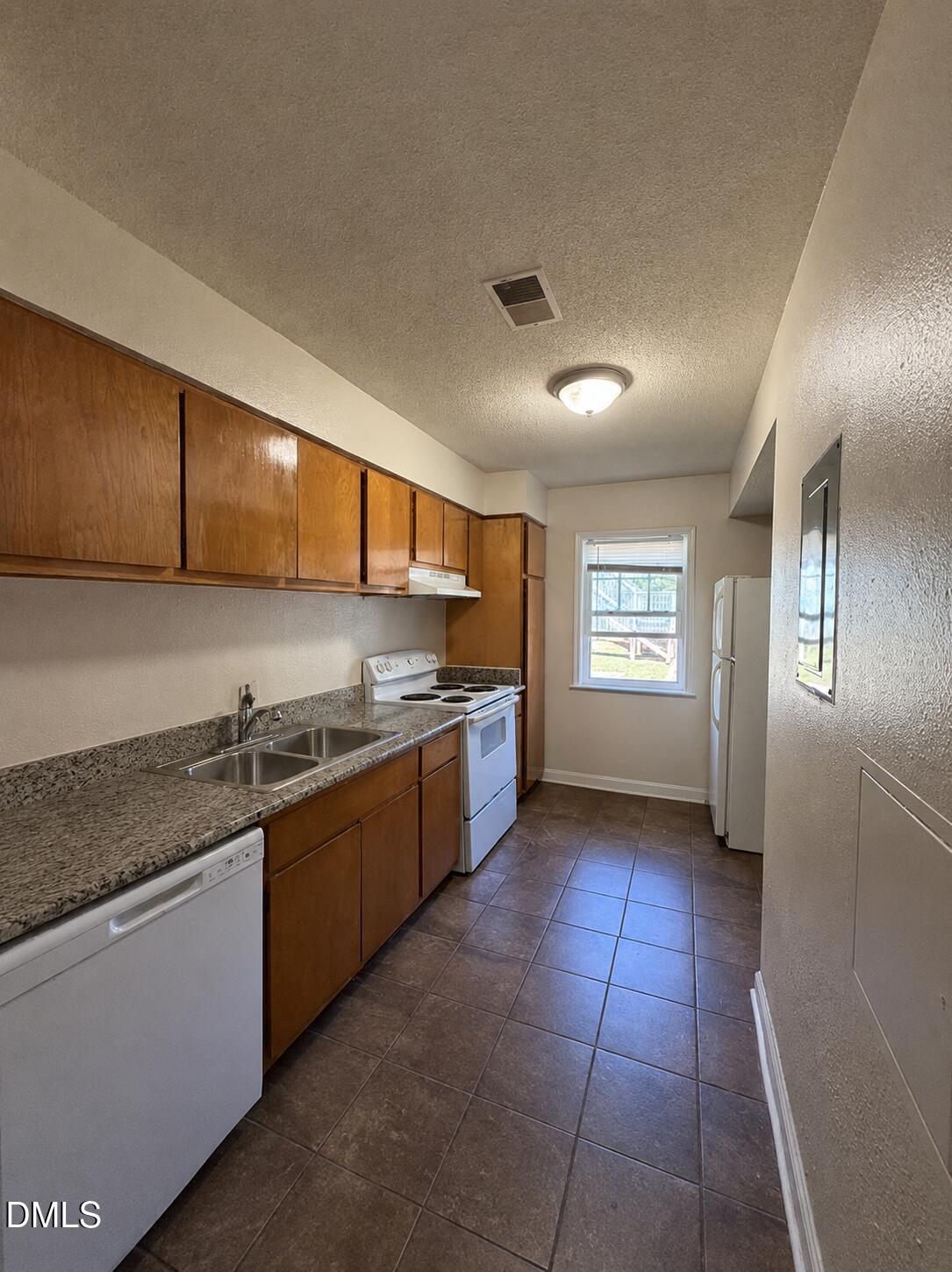 2506 Avent Ferry Road, Unit 101 Raleigh, NC 27606 - Photo 10 of 19 a large kitchen with stainless steel appliances granite countertop a sink and a stove
