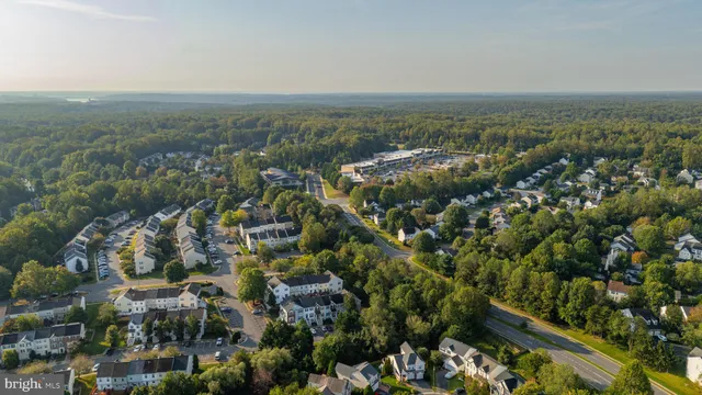 a kitchen with stainless steel appliances granite countertop a refrigerator stove a sink and dishwasher with wooden cabinet