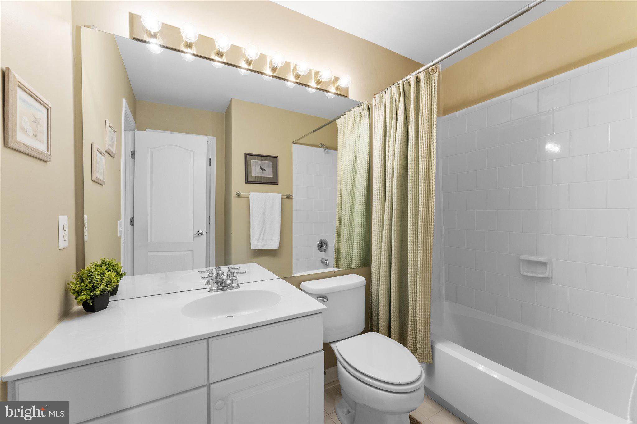 20900 Trinity Square Sterling, VA 20165 - Photo 16 of 46 a bathroom with a sink a toilet a mirror a vanity and shower