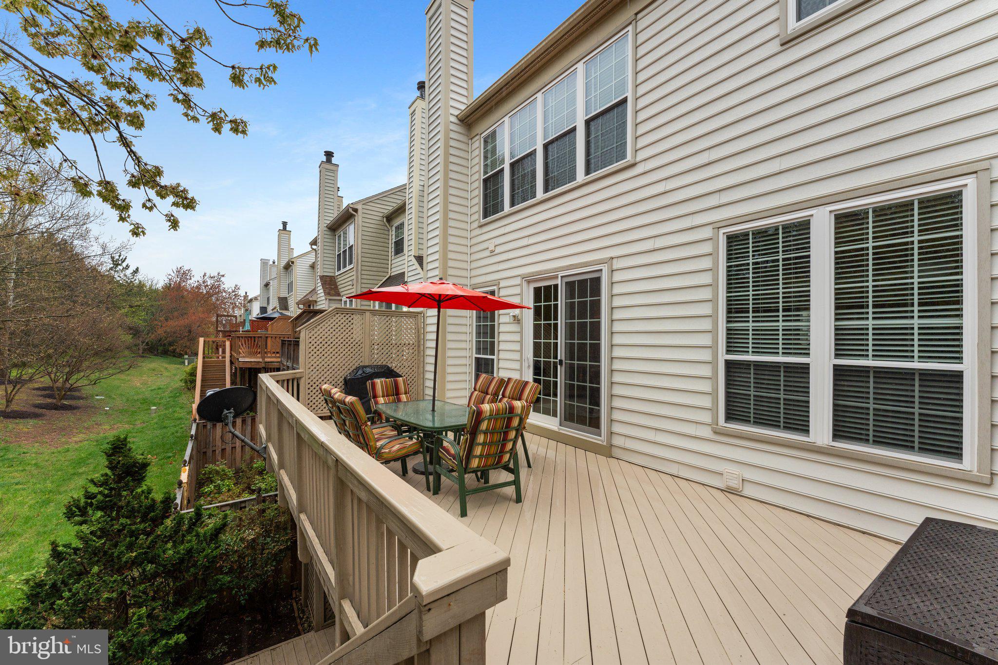 20900 Trinity Square Sterling, VA 20165 - Photo 41 of 46 a view of deck with a table and chairs and potted plants