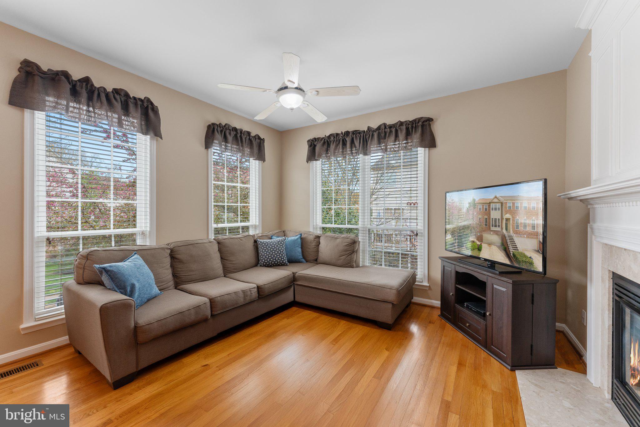 20900 Trinity Square Sterling, VA 20165 - Photo 6 of 46 a living room with furniture and a flat screen tv
