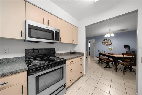 a kitchen with a stove a microwave and wooden cabinets
