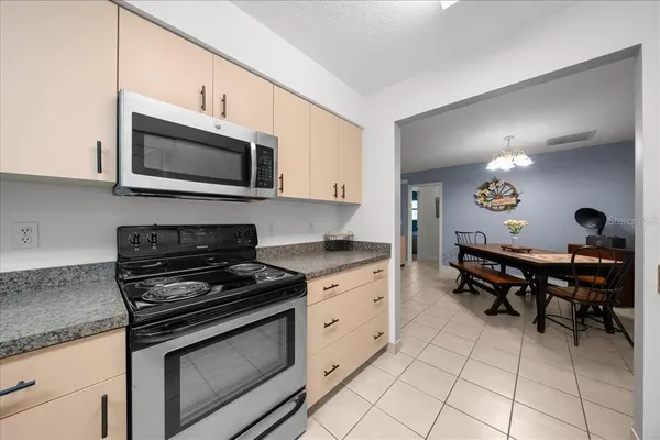 a kitchen with a stove a microwave and wooden cabinets