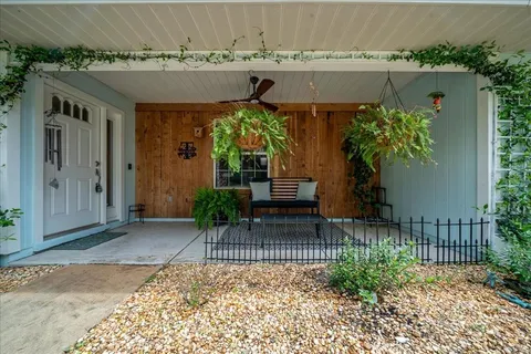 a view of balcony with furniture and wooden floor