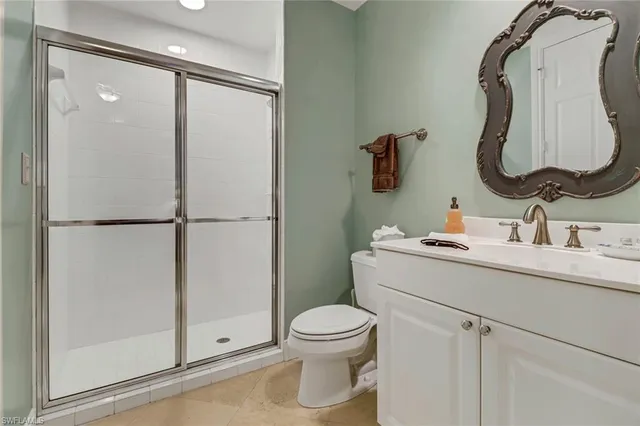 a bathroom with a sink vanity mirror and toilet
