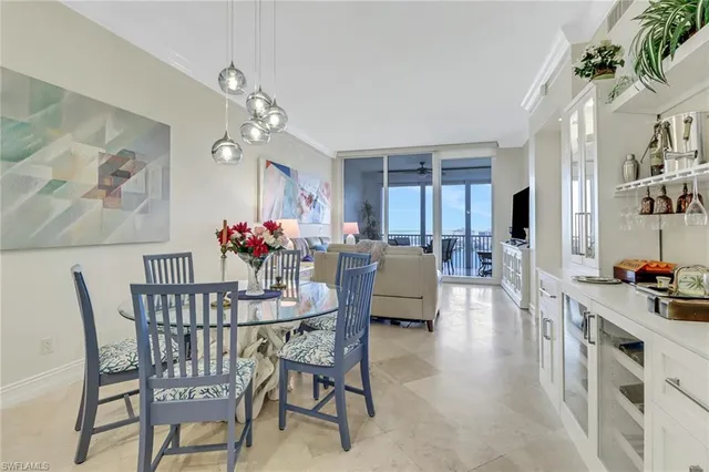 a view of a dining room with furniture and a chandelier