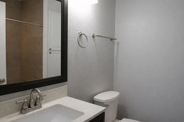 a bathroom with a sink toilet and shower