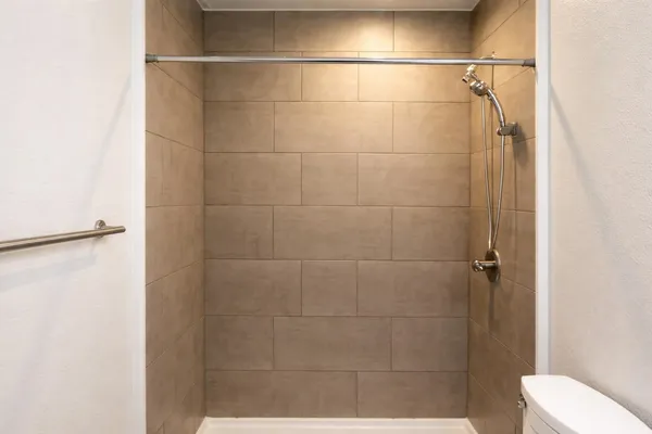 a bathroom with a shower and a toilet