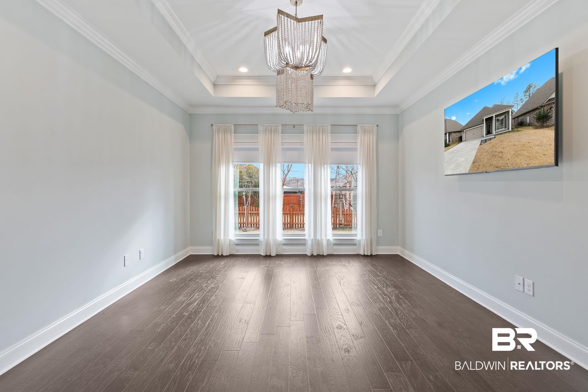 31654 Canopy Loop Daphne, AL 36527 - Photo 29 of 64 Unfurnished room featuring a chandelier, dark wood-style floors, and a tray ceiling