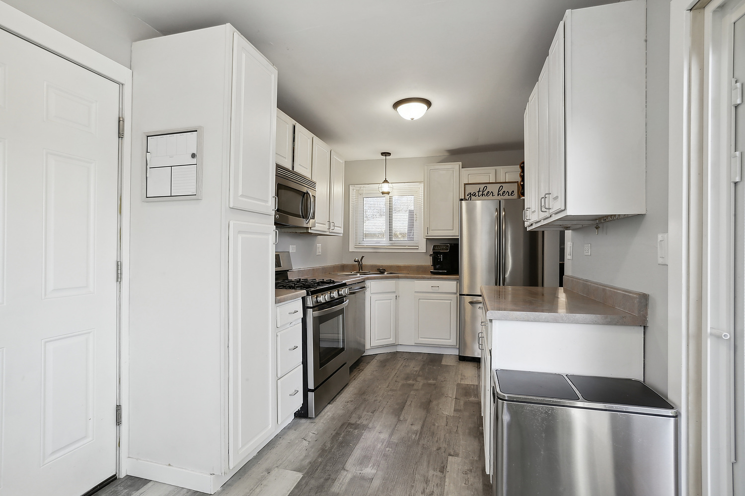 647 Rockhurst Road Bolingbrook, IL 60440 - Photo 5 of 14 a kitchen with white cabinets and stainless steel appliances