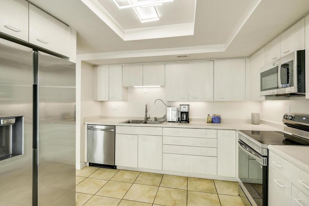 7585 Eads Avenue, Unit C La Jolla, CA 92037 - Photo 14 of 29 a kitchen with stainless steel appliances granite countertop a sink and a refrigerator