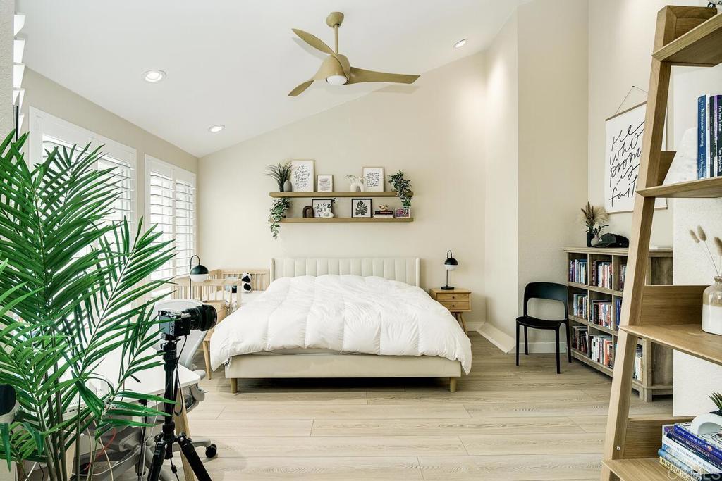 7585 Eads Avenue, Unit C La Jolla, CA 92037 - Photo 17 of 29 a bedroom with a bed and a chandelier