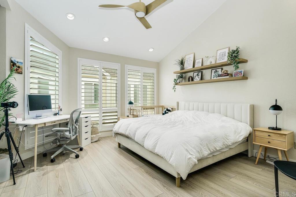 7585 Eads Avenue, Unit C La Jolla, CA 92037 - Photo 18 of 29 a bedroom with a bed and large windows