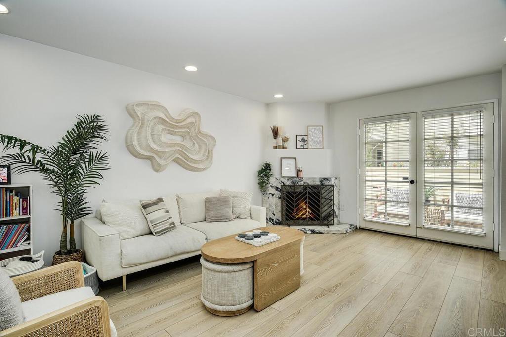 7585 Eads Avenue, Unit C La Jolla, CA 92037 - Photo 2 of 29 a living room with furniture large window and wooden floor
