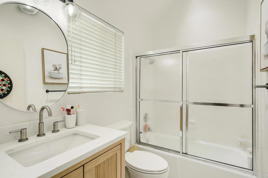 7585 Eads Avenue, Unit C La Jolla, CA 92037 - Photo 21 of 29 a bathroom with a sink toilet and shower