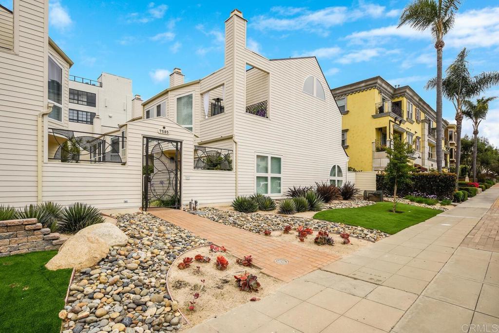 7585 Eads Avenue, Unit C La Jolla, CA 92037 - Photo 22 of 29 a view of a white house with a yard