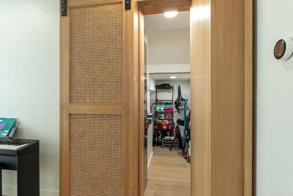 7585 Eads Avenue, Unit C La Jolla, CA 92037 - Photo 7 of 29 a view of a hallway with a closet and storage area