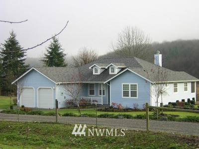5047 194th Lane Southwest Rochester, WA 98579 - Photo 1 of 1 a front view of a house with a yard