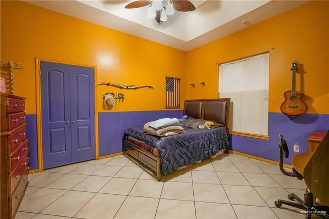 a bedroom with a bed and dresser with mirror