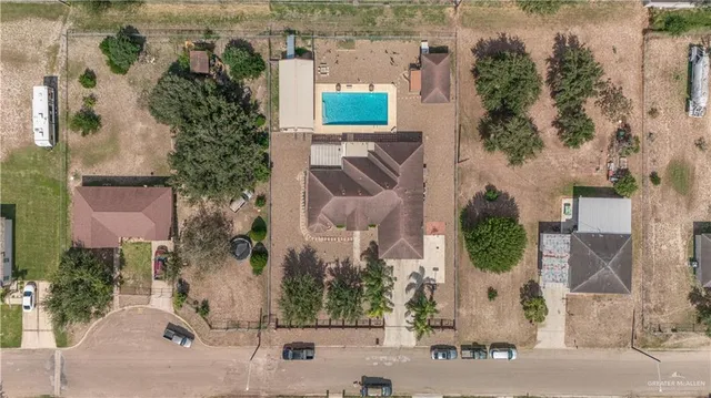 an aerial view of a house with a yard and garden