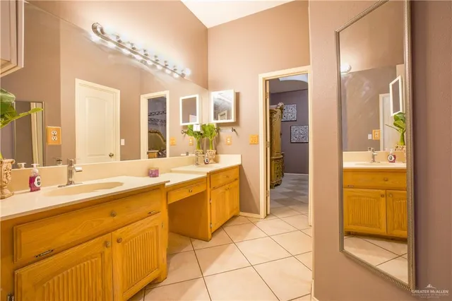 a large bathroom with a large mirror vanity and a sink