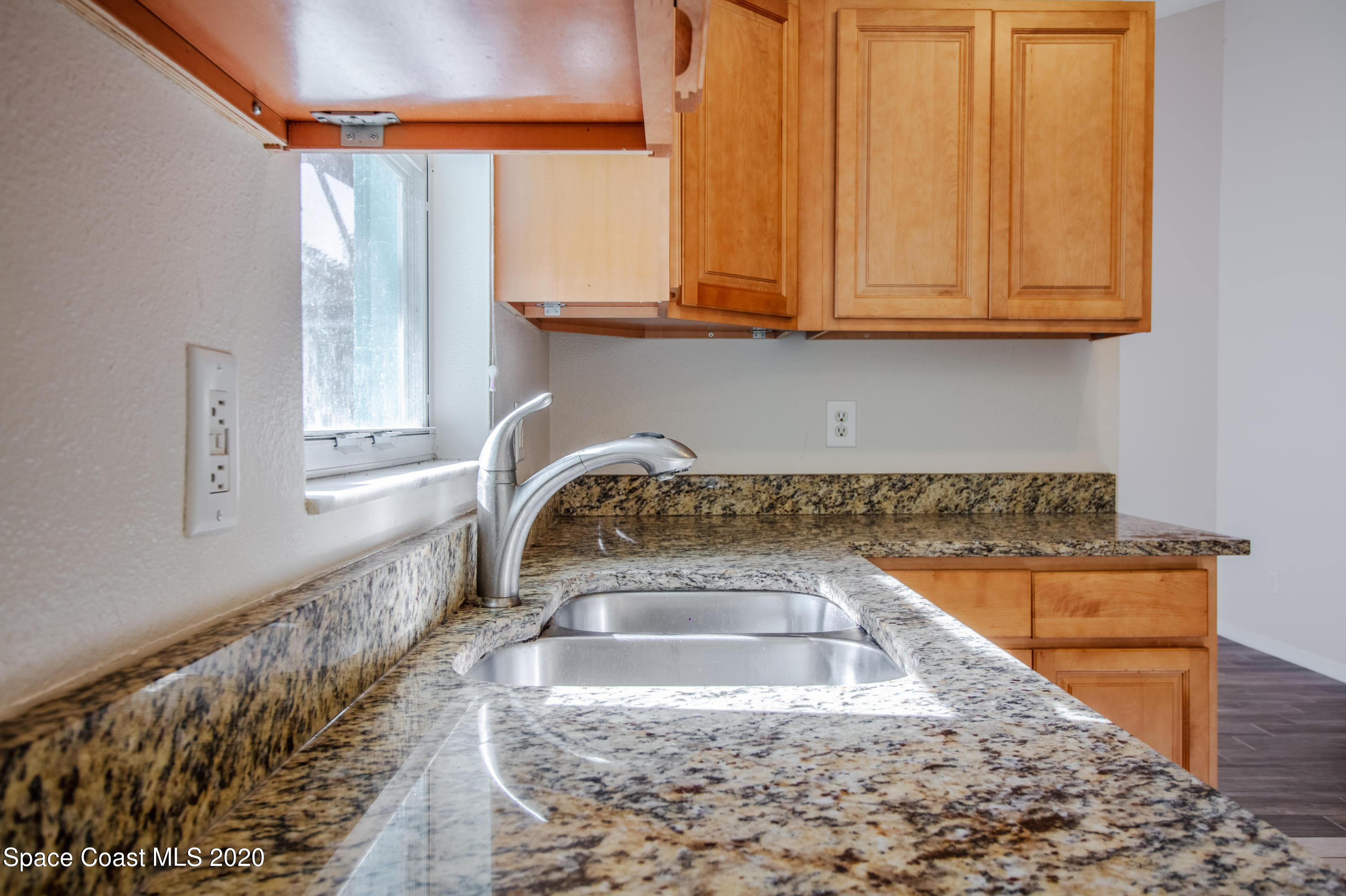 5345 Cangro Street Cocoa, FL 32926 - Photo 14 of 28 a kitchen with a sink and a stove top oven