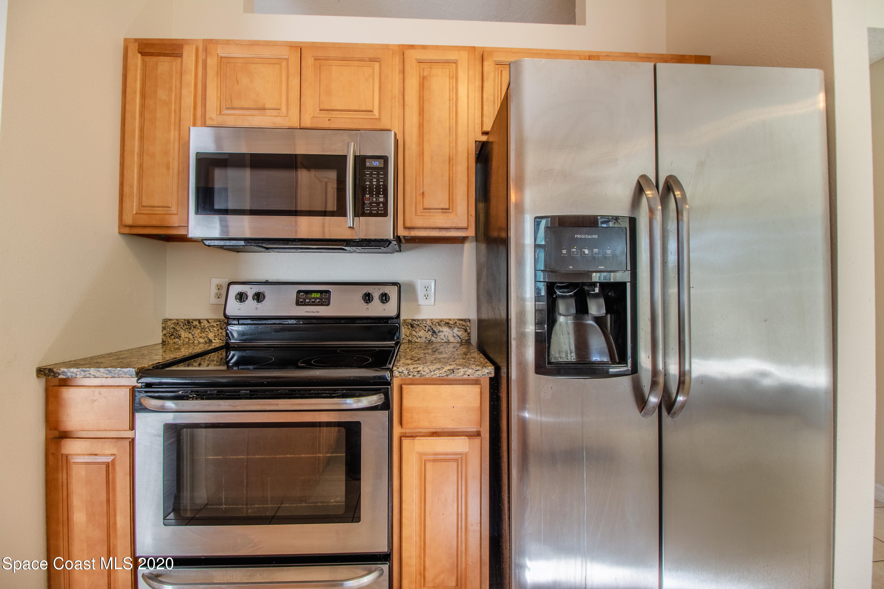 5345 Cangro Street Cocoa, FL 32926 - Photo 15 of 28 a kitchen with a stove and a microwave