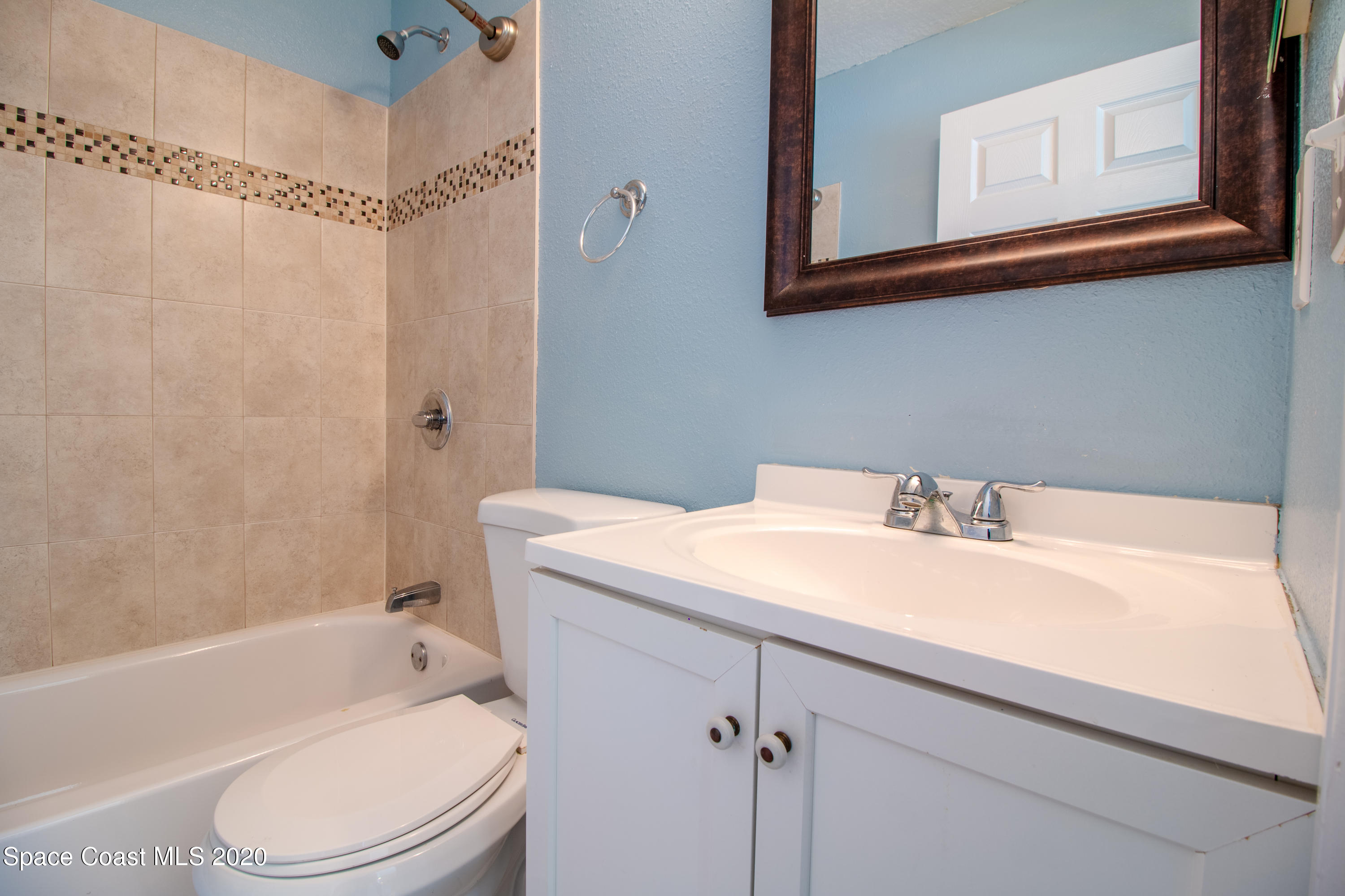 5345 Cangro Street Cocoa, FL 32926 - Photo 18 of 28 a bathroom with a sink a toilet and shower