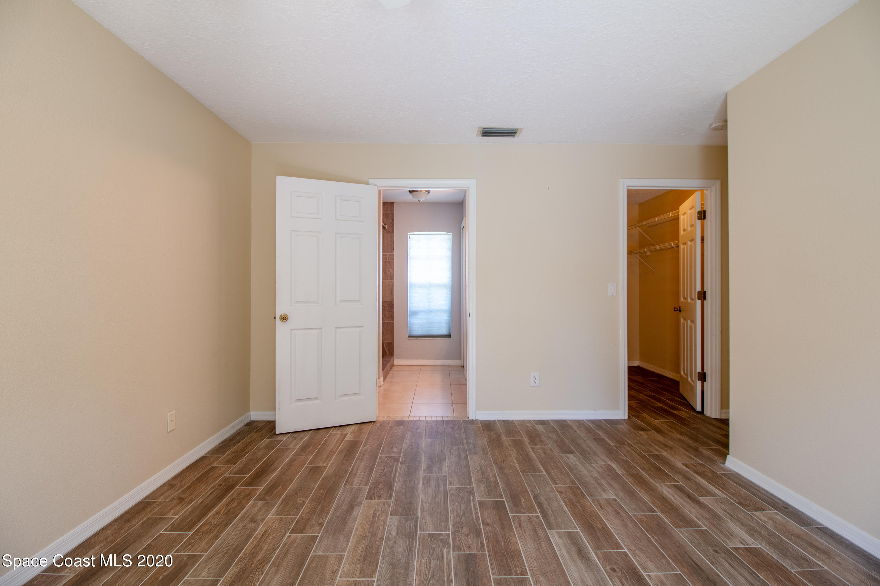 5345 Cangro Street Cocoa, FL 32926 - Photo 23 of 28 a view of an empty room with wooden floor and closet