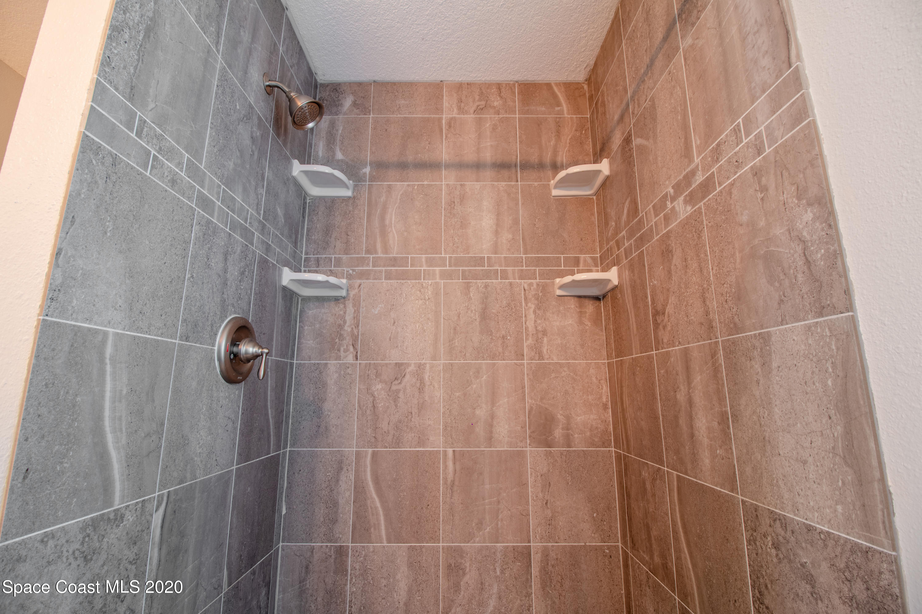 5345 Cangro Street Cocoa, FL 32926 - Photo 25 of 28 a bathroom with a shower