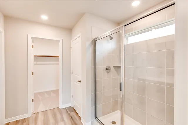 a bathroom with a glass shower door