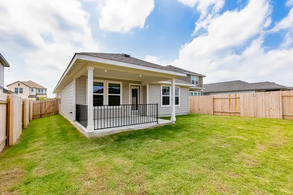 a view of a house with backyard and garden