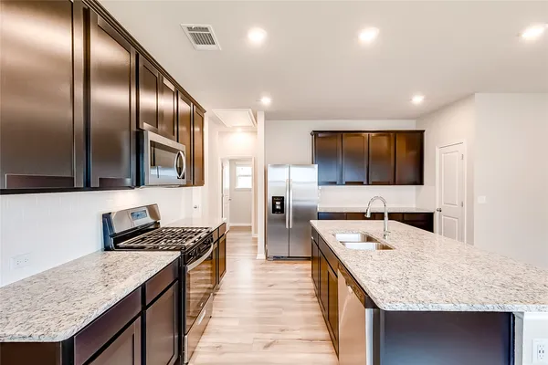 a kitchen with stainless steel appliances granite countertop counter space a sink and cabinets