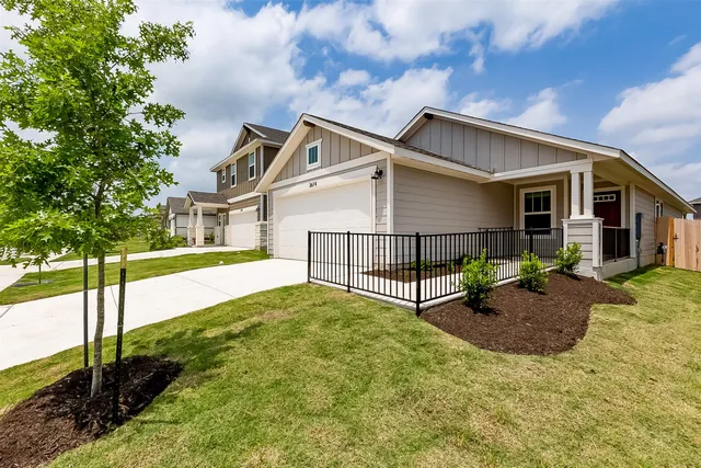 a view of backyard with a small cabin and wooden fence