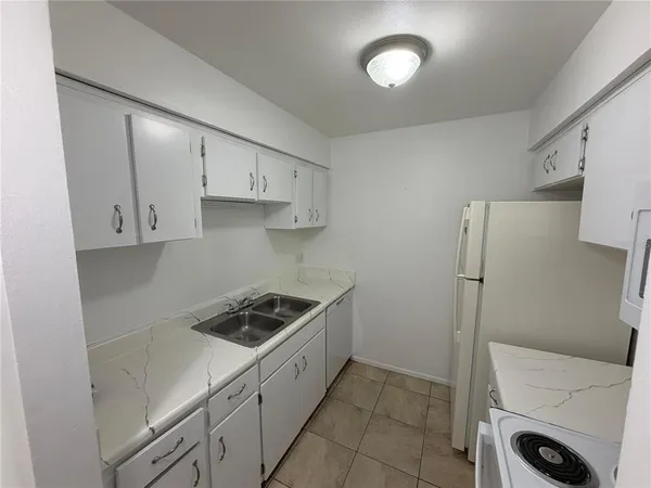 a kitchen with cabinets and a stove top oven