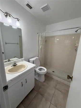 a bathroom with a toilet sink and shower