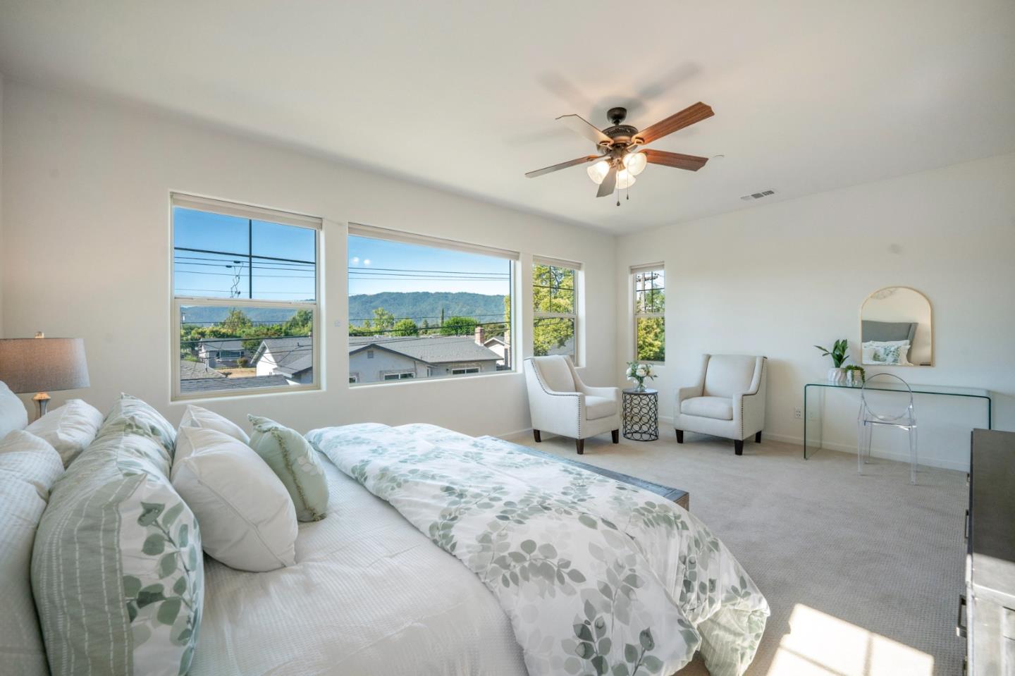 712 Baxter Way Gilroy, CA 95020 - Photo 23 of 37 a spacious bedroom with a large bed and a chandelier