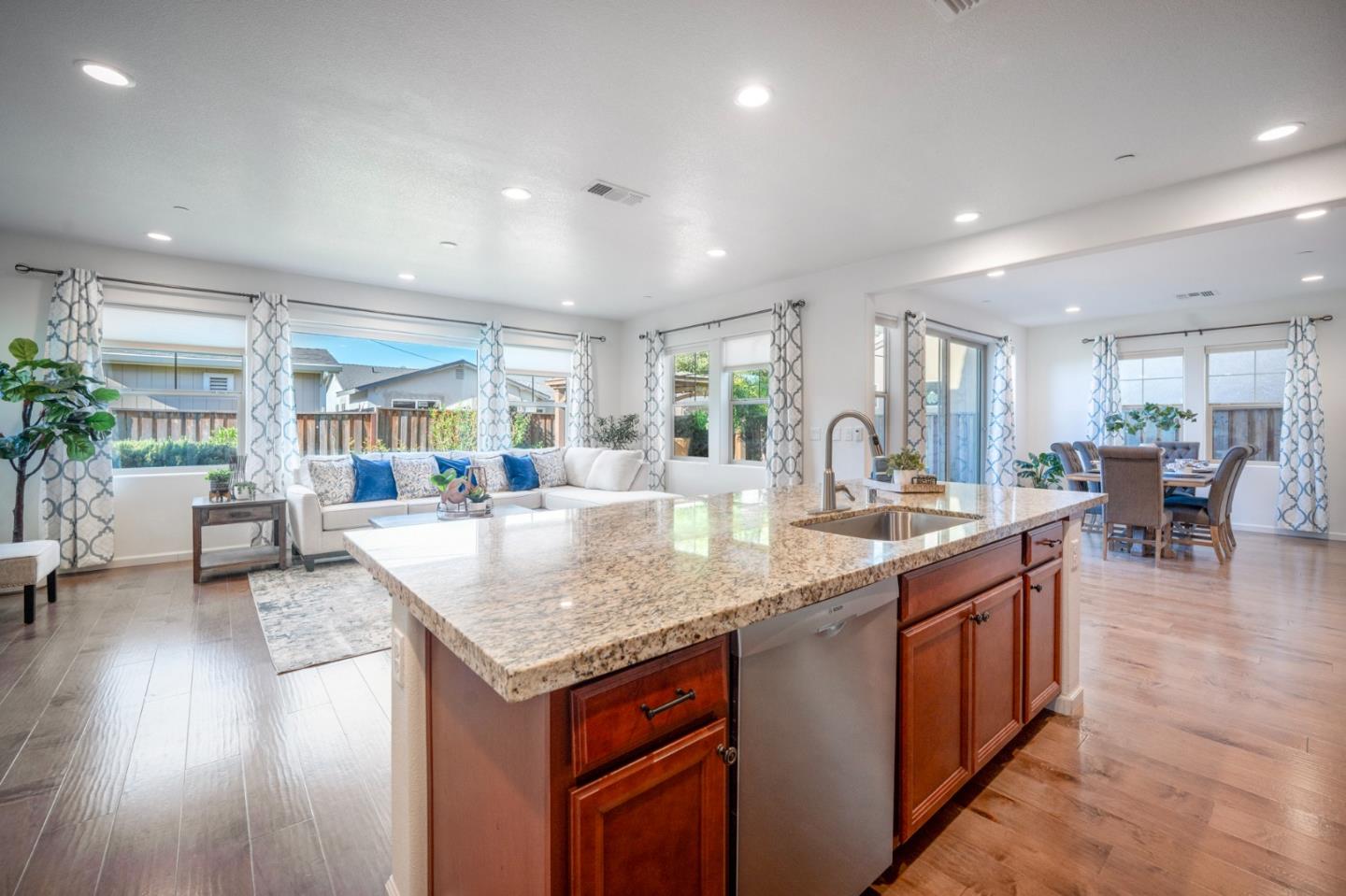 712 Baxter Way Gilroy, CA 95020 - Photo 3 of 37 a kitchen with center island wooden floor and a large window