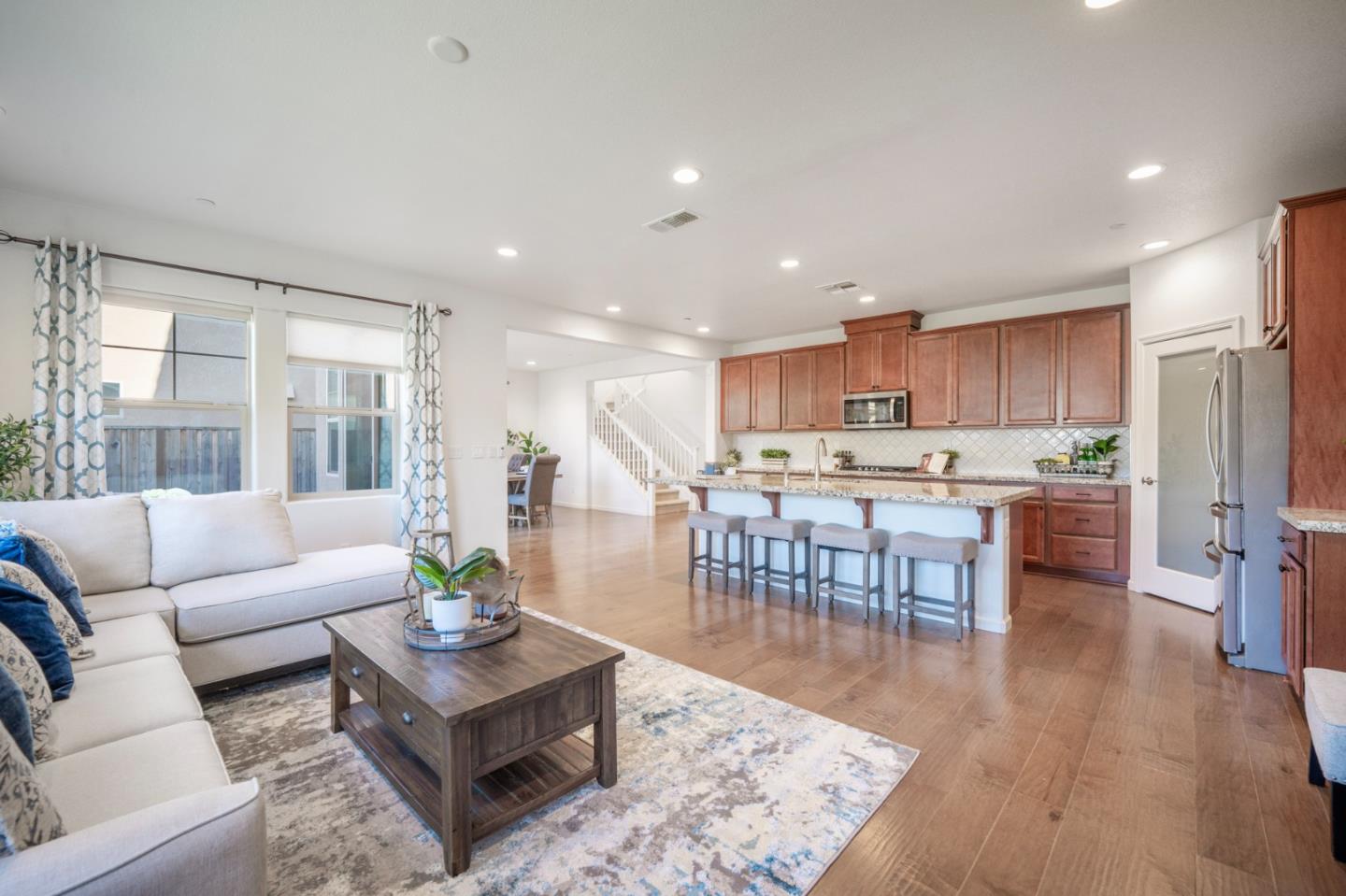 712 Baxter Way Gilroy, CA 95020 - Photo 7 of 37 a living room with furniture wooden floor and kitchen view