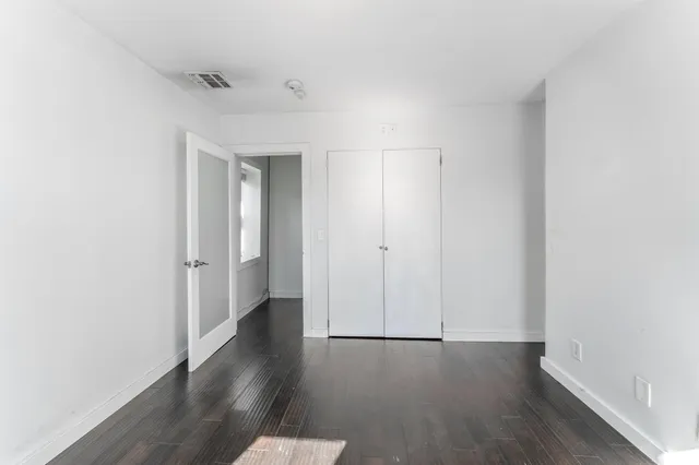 a kitchen with a stove and white cabinets