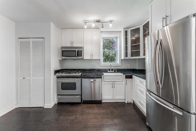 a kitchen with a refrigerator stove and microwave