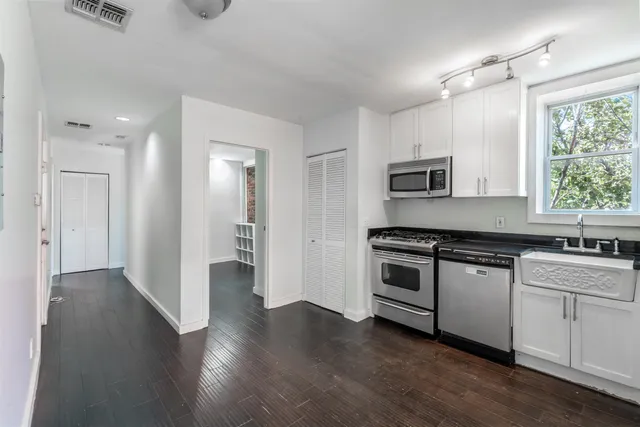 a kitchen with stainless steel appliances granite countertop a stove and a sink