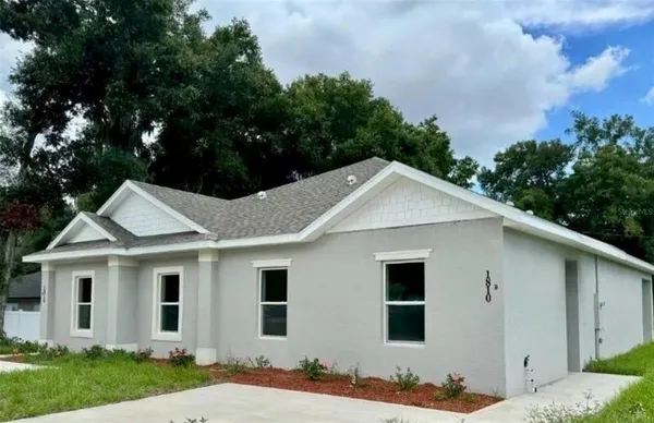 a view of a yard in front view of a house