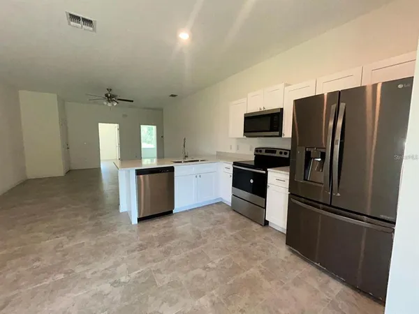 a kitchen with a refrigerator and a sink