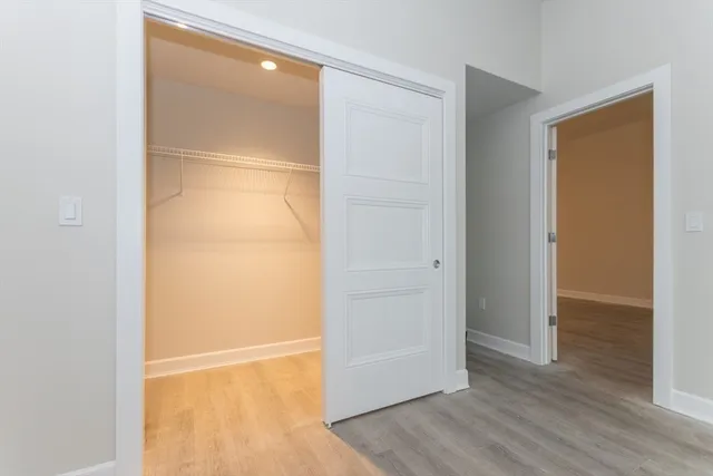 a view of empty room with wooden floor