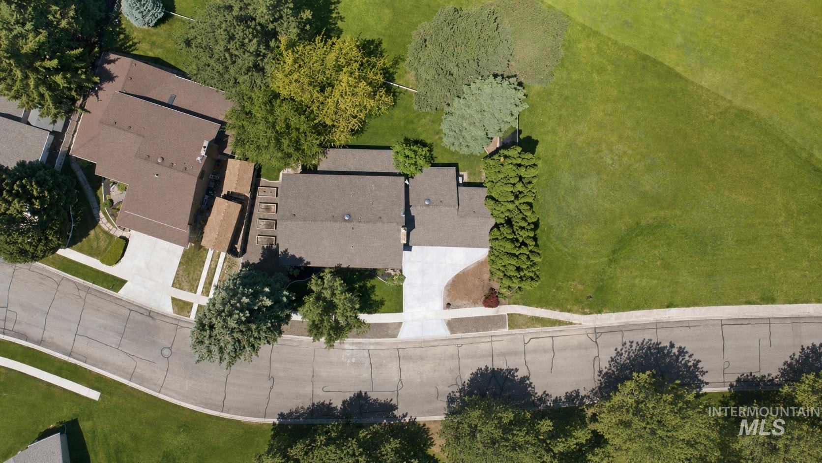 599 Pebble Beach Way Eagle, ID 83616 - Photo 37 of 44 Aerial view showcasing a residential property with a multi-gabled roof and a concrete driveway